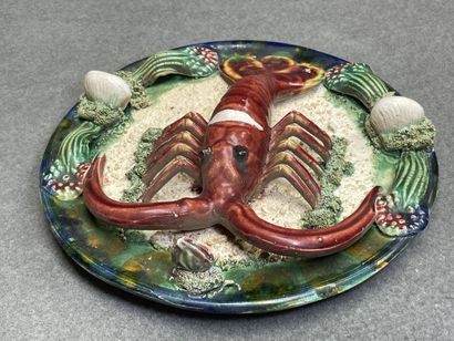 Deux plats en barbotine à décor de homard....