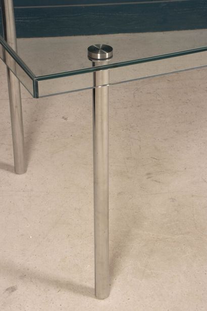 Glass table, chrome-plated metal legs. 
74...
