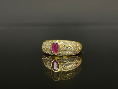 Gold ring set with a close-set ruby and pavé-set...