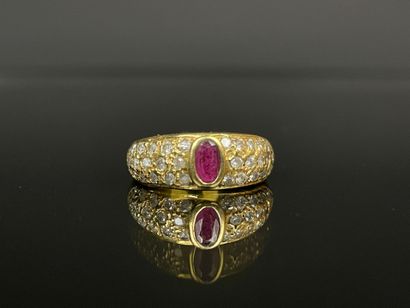 Gold ring set with a close-set ruby and pavé-set...