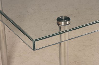 Glass table, chrome-plated metal legs. 
74...