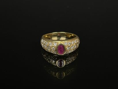 Gold ring set with a close-set ruby and pavé-set...