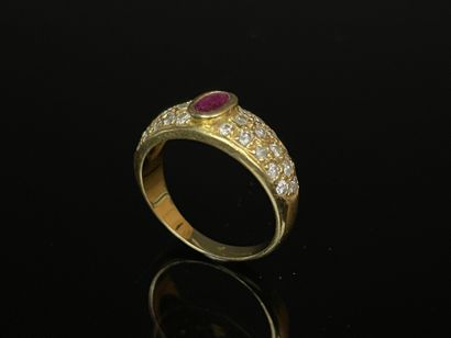 Gold ring set with a close-set ruby and pavé-set...