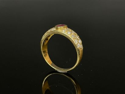 Gold ring set with a close-set ruby and pavé-set...