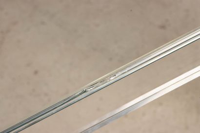 Glass table, chrome-plated metal legs. 
74...