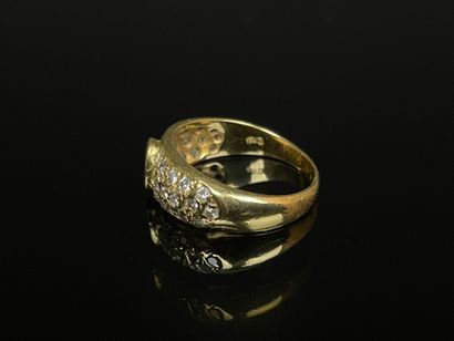 Gold ring set with a close-set ruby and pavé-set...