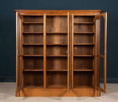 Large molded oak bookcase, opening to three...