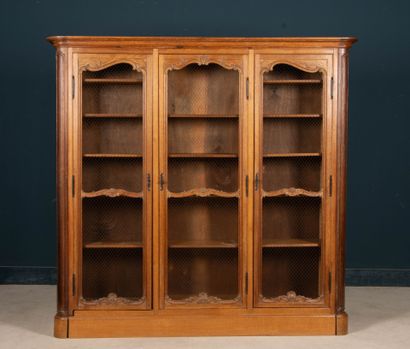 Large molded oak bookcase, opening to three...