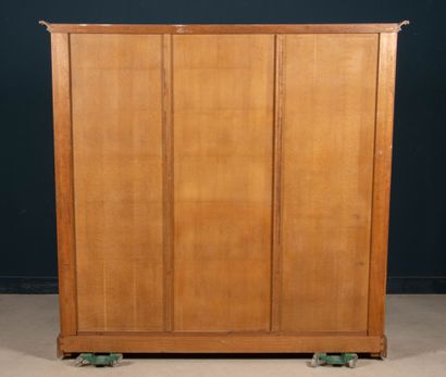 Large molded oak bookcase, opening to three...