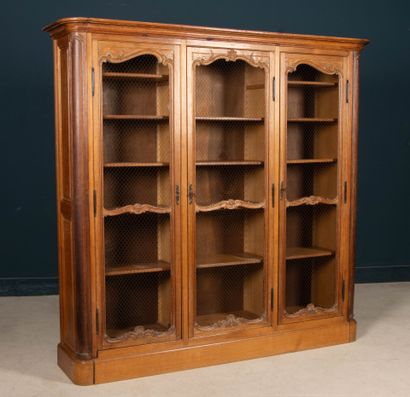 Large molded oak bookcase, opening to three...
