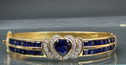 Bracelet jonc en or, serti de pierres bleues...