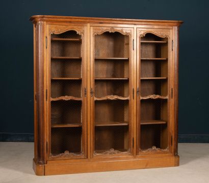 Large molded oak bookcase, opening to three...