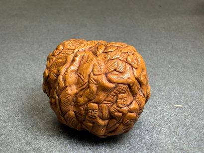 Deux Noix sculptées de personnages et d'animaux....