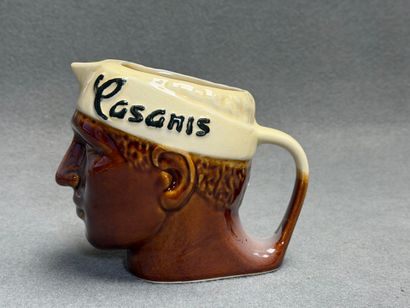 CASANIS. 
Pichet en faïence émaillée représentant...