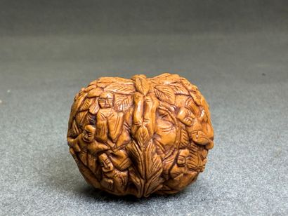 Deux Noix sculptées de personnages et d'animaux....