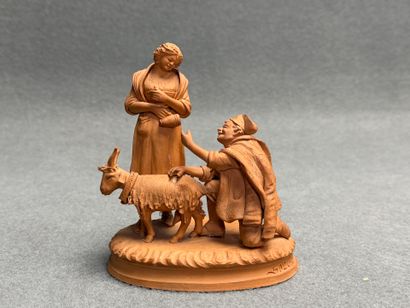 Couple et chèvre. 
Groupe en terre cuite...