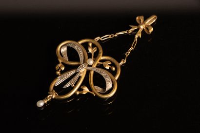 Gold pendant featuring a scroll supported...