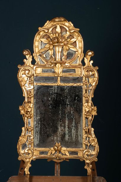 Wood and gilded stucco mirror with a pediment...