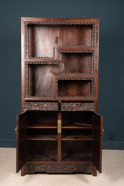 Richly carved exotic wood shelf with two...