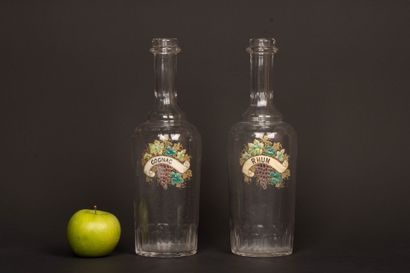Two glass decanters with enameled vine blossom...