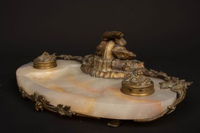 A desk with an alabaster top, bronze sculpture...