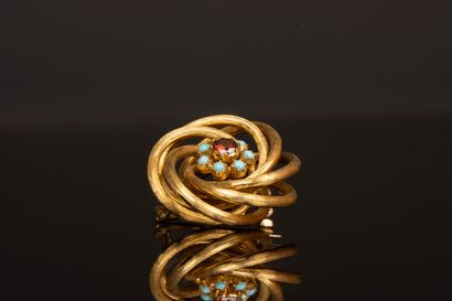 Swirl brooch in gold with orange semi-precious...