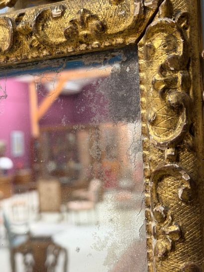 Wood and gilded stucco mirror with parecloses...