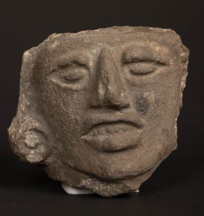 Reunion of two carved stone fragments depicting...