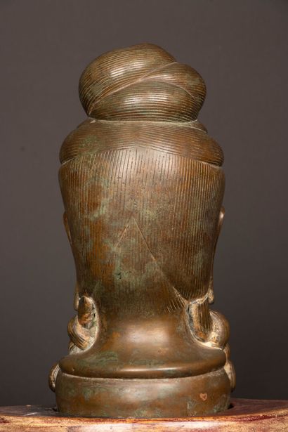 Patinated bronze Buddha head on wooden base....