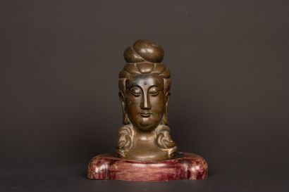 Patinated bronze Buddha head on wooden base....