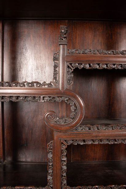 Richly carved exotic wood shelf with two...