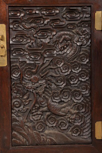 Richly carved exotic wood shelf with two...
