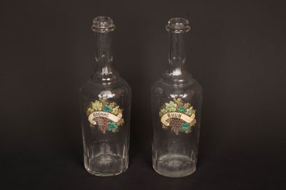 Two glass decanters with enameled vine blossom...