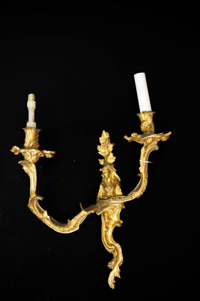 Pair of gilt bronze sconces with two asymmetrical...