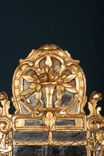 Wood and gilded stucco mirror with a pediment...