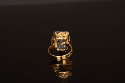 Yellow gold ring set with an emerald-cut...