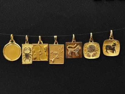Five gold medals decorated with astrological...