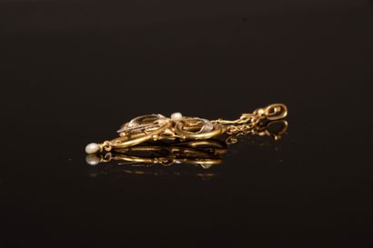 Gold pendant featuring a scroll supported...