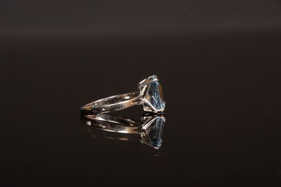 White gold ring set with an emerald-cut aquamarine...