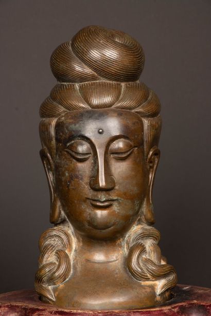 Patinated bronze Buddha head on wooden base....