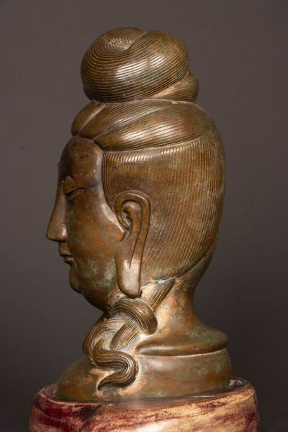 Patinated bronze Buddha head on wooden base....