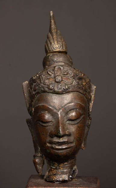 Crowned Buddha head in bronze with brown...