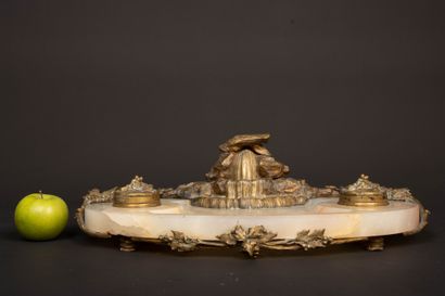 A desk with an alabaster top, bronze sculpture...