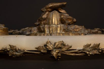 A desk with an alabaster top, bronze sculpture...