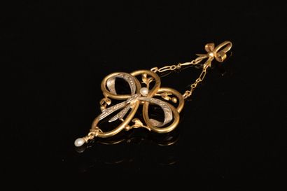 Gold pendant featuring a scroll supported...