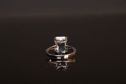 White gold ring set with an emerald-cut aquamarine...
