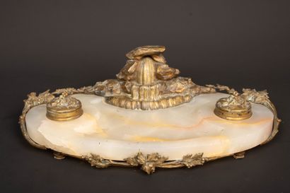 A desk with an alabaster top, bronze sculpture...