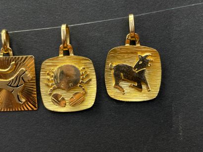 Five gold medals decorated with astrological...