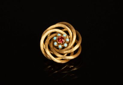Swirl brooch in gold with orange semi-precious...