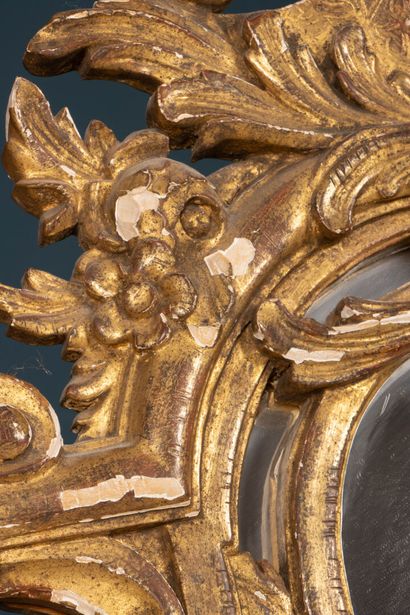 Wood and gilded stucco mirror with parecloses...